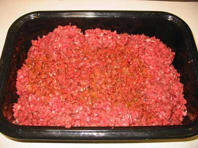 Pour the seasoning/water over the meat and mix by hand until you can't feel your fingers any more. (This is really cold meat)
